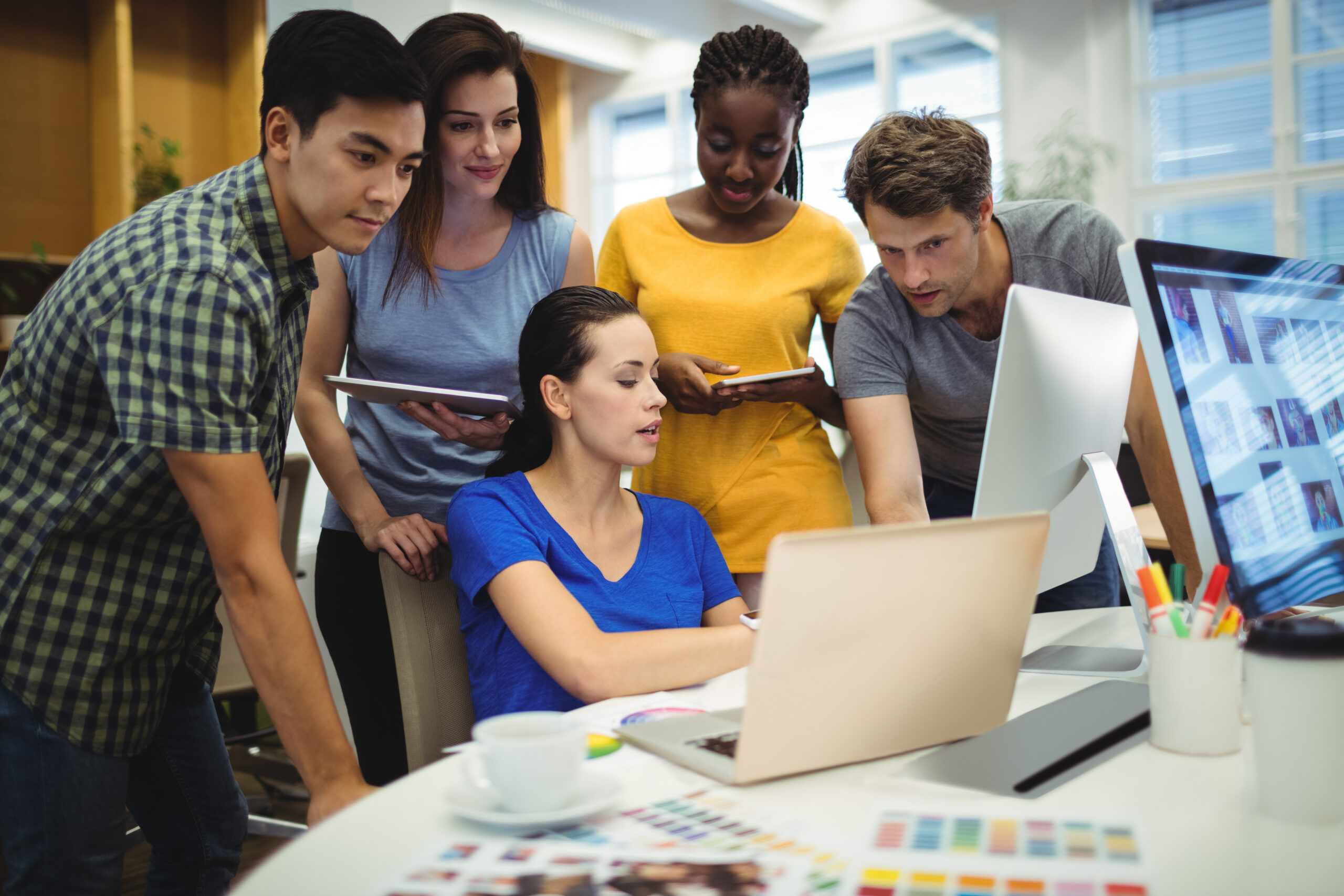 Graphic designers discussing over laptop in the office